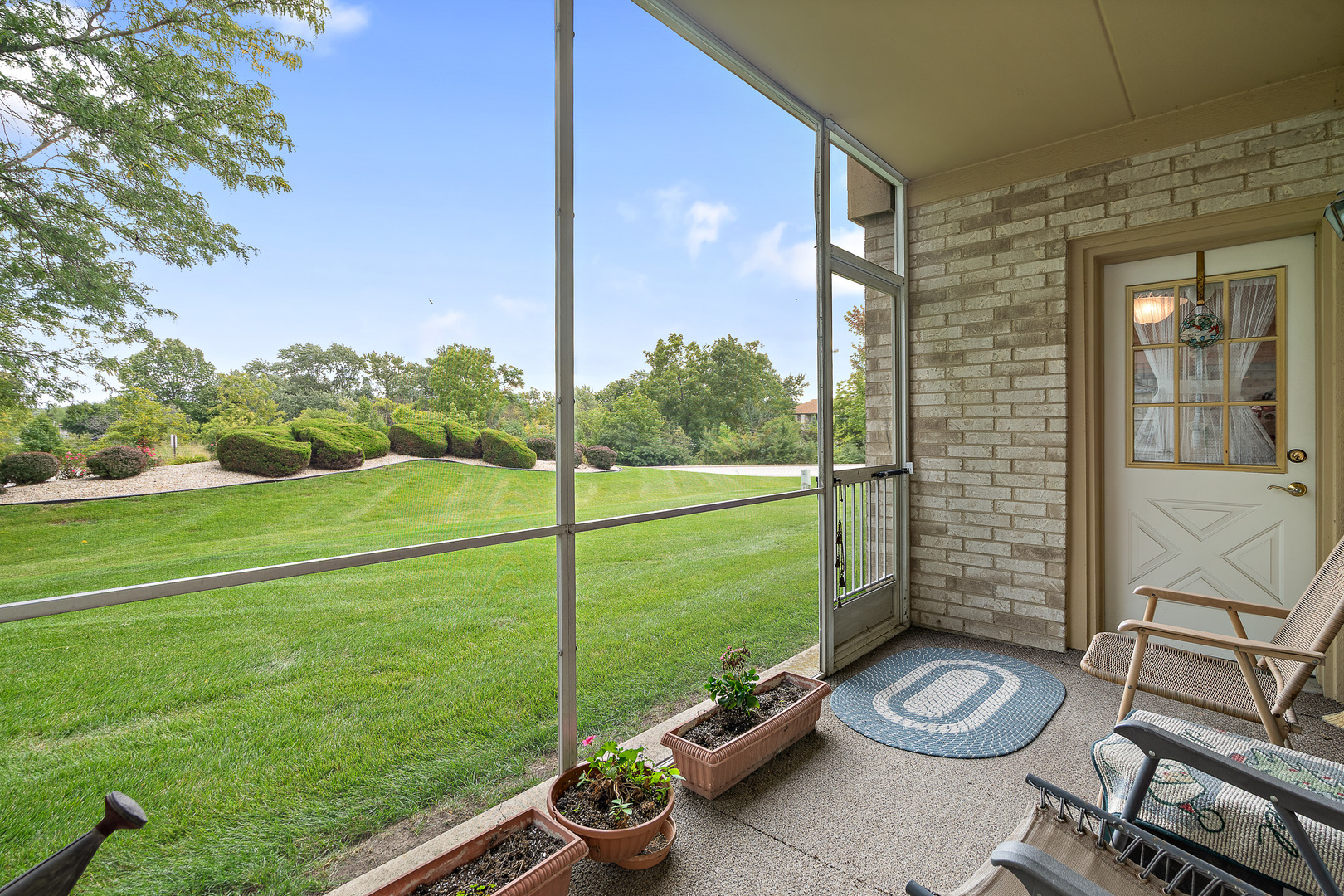 18431 Pine Cone Drive, Unit 1 Tinley Park, IL 60477 - Photo 2 of 33 a view of a backyard with sitting area