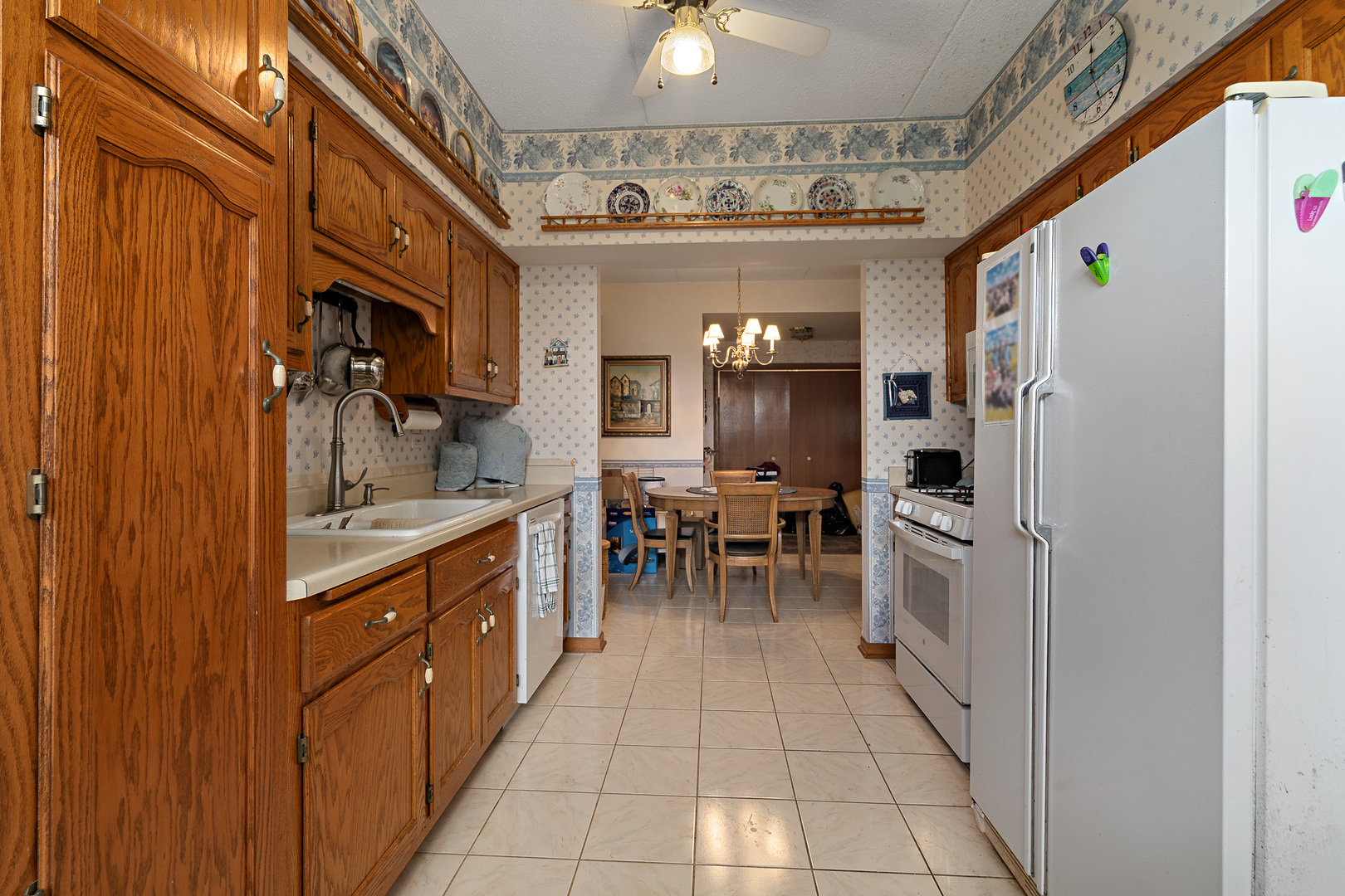 18431 Pine Cone Drive, Unit 1 Tinley Park, IL 60477 - Photo 8 of 33 a kitchen with stainless steel appliances granite countertop a refrigerator and a sink
