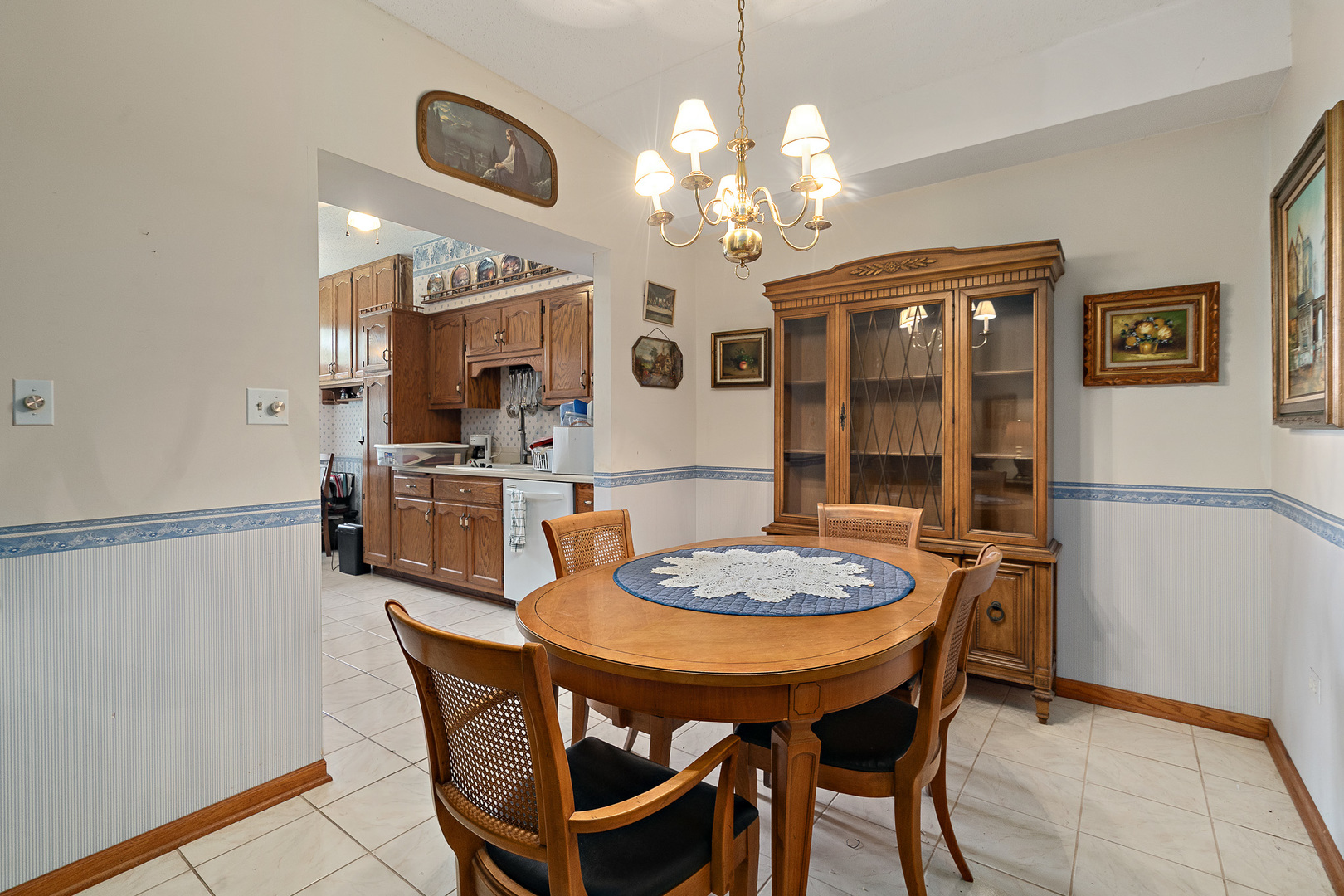 18431 Pine Cone Drive, Unit 1 Tinley Park, IL 60477 - Photo 10 of 33 a dining room with furniture a chandelier and wooden floor