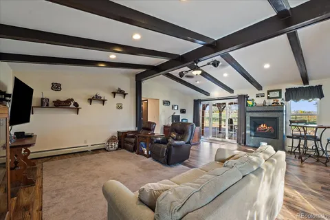 a living room with furniture gym equipment and a large window
