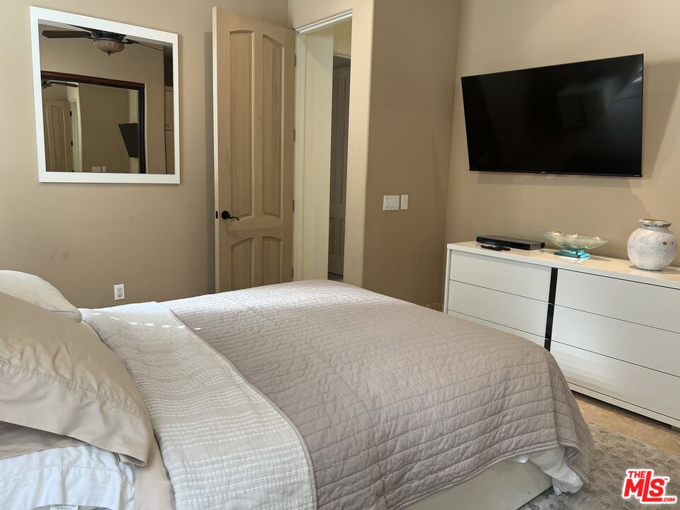 31280 Bailard Road Malibu, CA 90265 - Photo 37 of 51 a bedroom with a bed and a flat screen tv