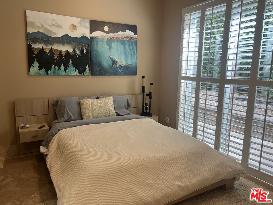 31280 Bailard Road Malibu, CA 90265 - Photo 40 of 51 a bedroom with a bed and a painting on the wall