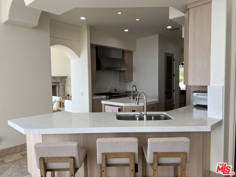 31280 Bailard Road Malibu, CA 90265 - Photo 42 of 51 a kitchen with kitchen island stainless steel appliances a sink and a refrigerator