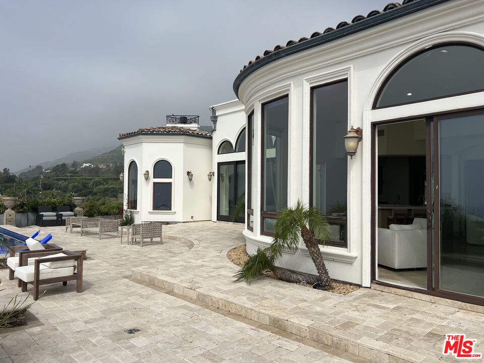 31280 Bailard Road Malibu, CA 90265 - Photo 43 of 51 a view of a white house with outdoor seating space