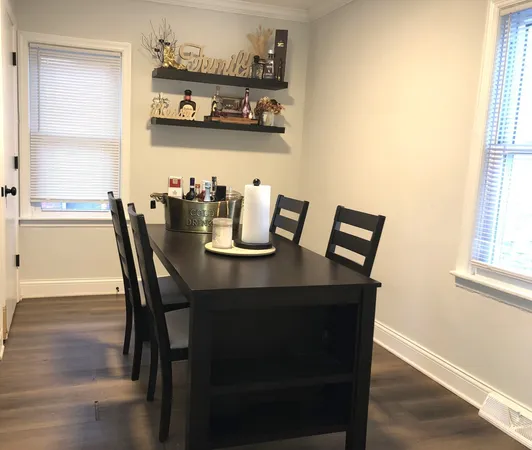 a view of a dining room with furniture and window