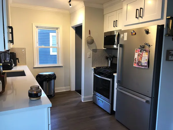 a kitchen with stainless steel appliances a refrigerator a stove a microwave and a refrigerator