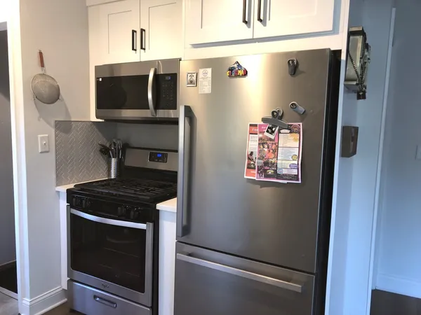 a kitchen with stainless steel appliances a refrigerator stove and microwave