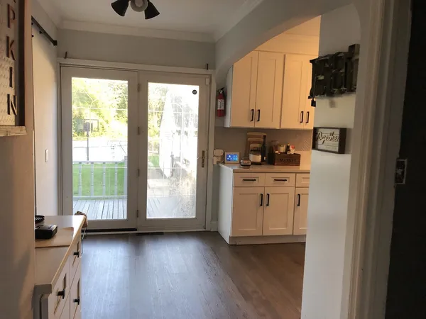 a kitchen with white cabinets and a window