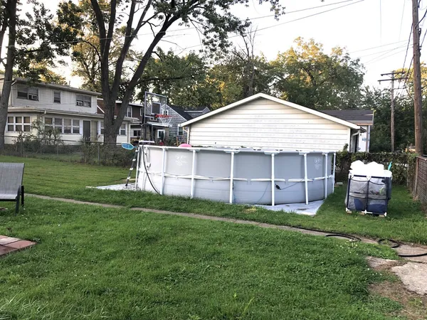 a view of a house with a yard and sitting area
