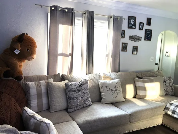 a living room with furniture and large window