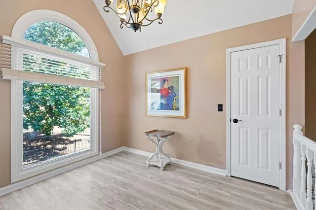 a bedroom with a large bed and a chandelier