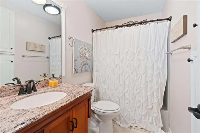 a view of a chair and table in backyard of the house