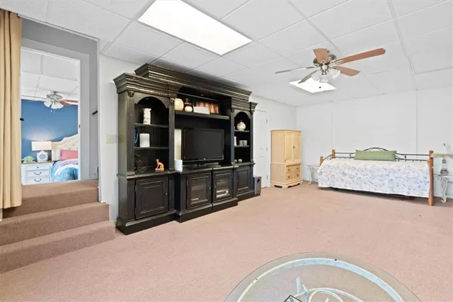 a backyard of a house with table and chairs under an umbrella