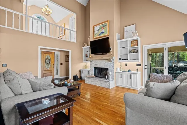 a balcony with wooden floor and lake view