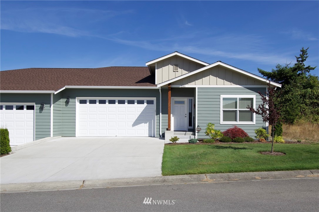 161 Stratus Loop Sequim, WA 98382 - Photo 2 of 34 a front view of a house with garden