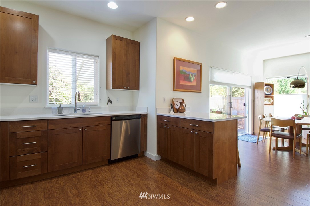 161 Stratus Loop Sequim, WA 98382 - Photo 12 of 34 a kitchen with stainless steel appliances granite countertop wooden cabinets a sink a stove a dining table and chairs