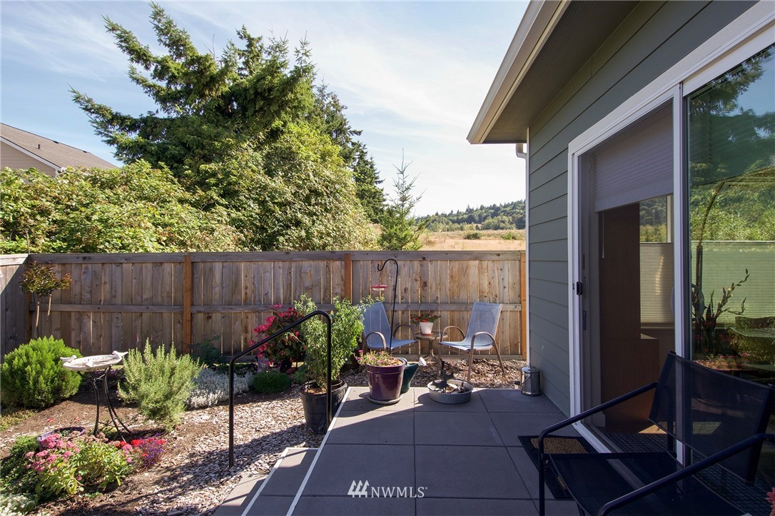 161 Stratus Loop Sequim, WA 98382 - Photo 13 of 34 a view of a chairs and table in backyard
