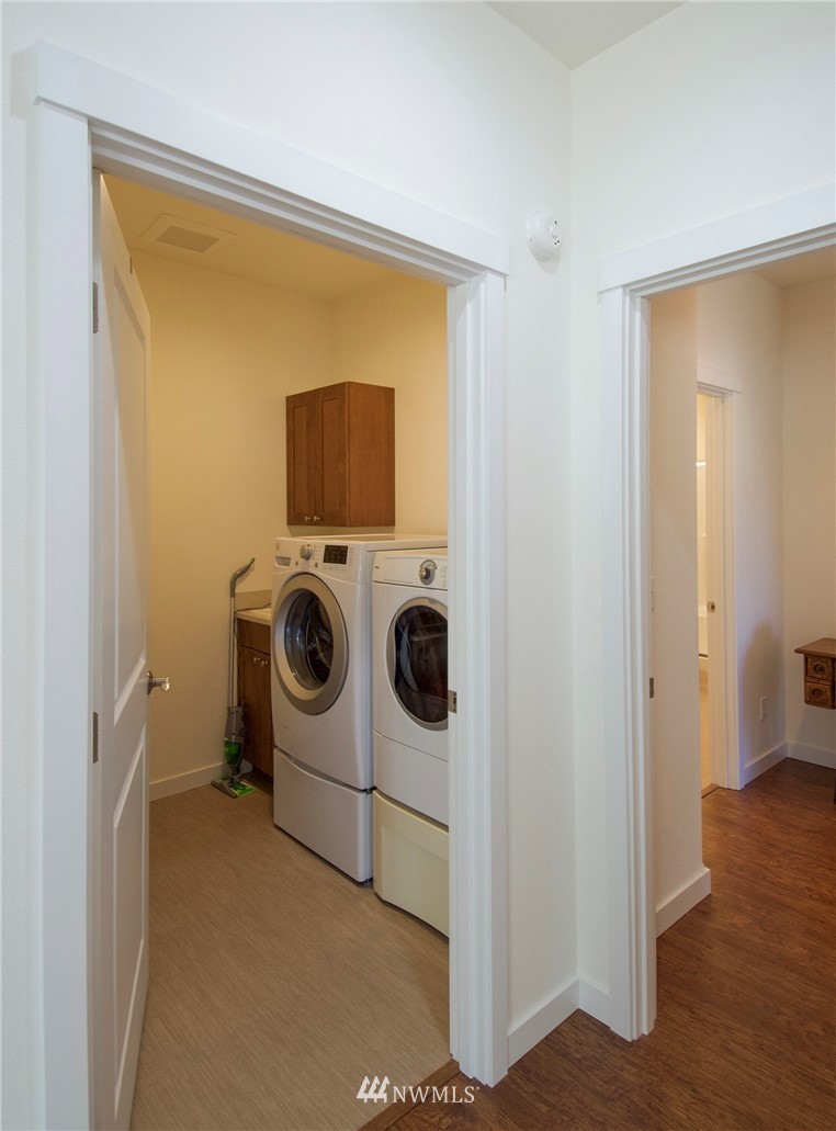 161 Stratus Loop Sequim, WA 98382 - Photo 17 of 34 a utility room with dryer washer and a view of living room