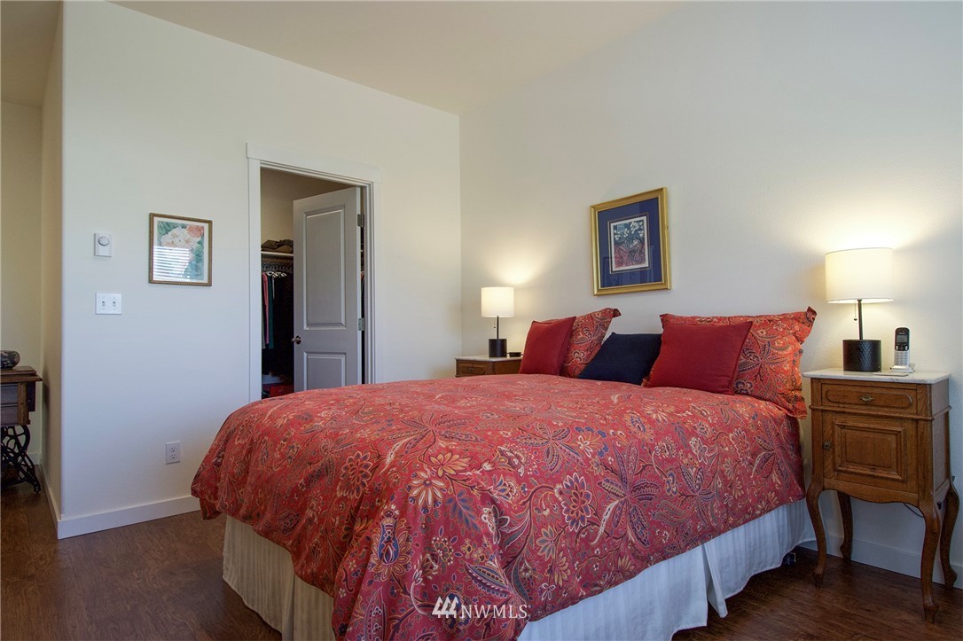 161 Stratus Loop Sequim, WA 98382 - Photo 19 of 34 a bedroom with a bed and wooden floor