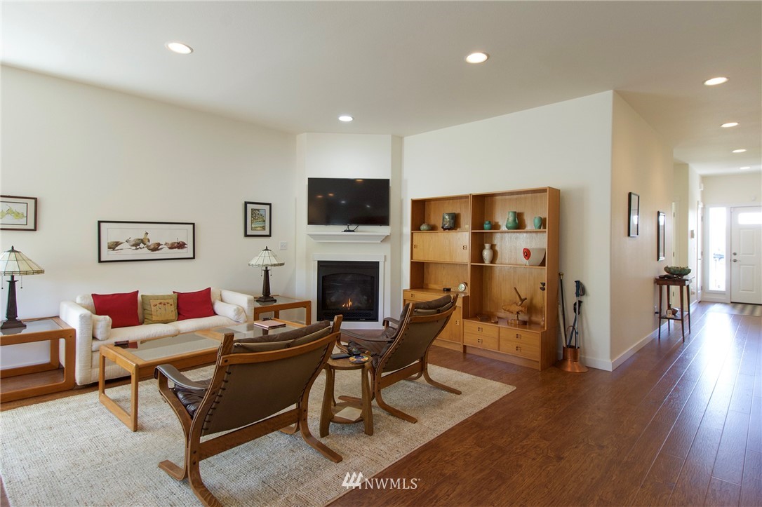 161 Stratus Loop Sequim, WA 98382 - Photo 3 of 34 a living room with furniture a fireplace and a table