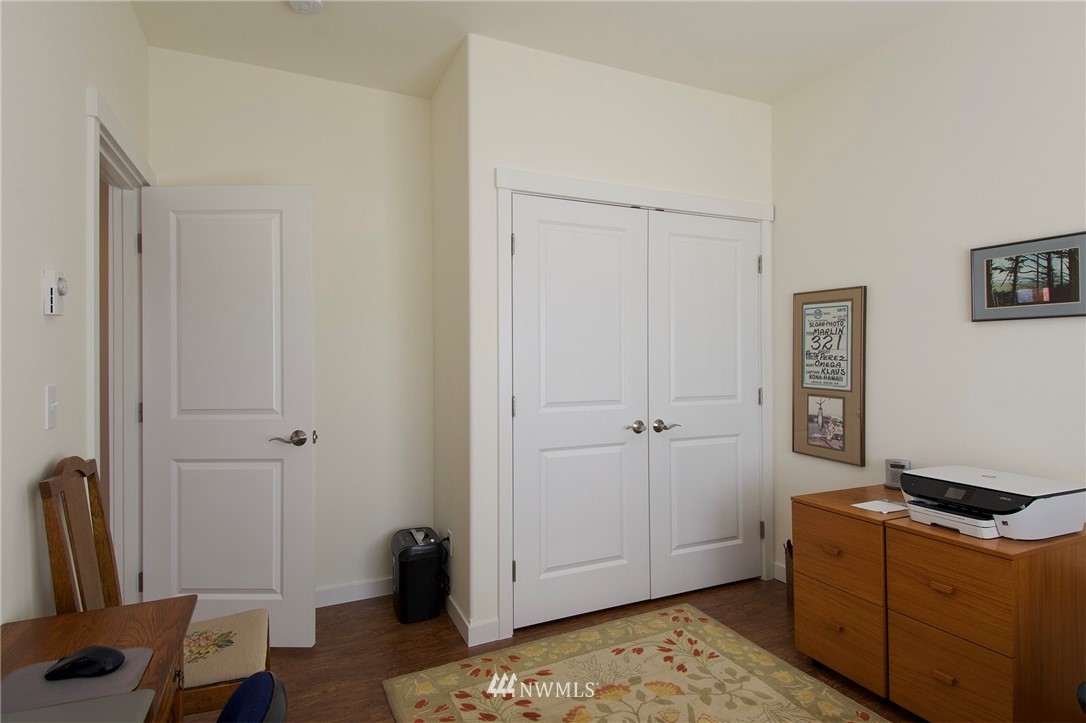 161 Stratus Loop Sequim, WA 98382 - Photo 30 of 34 a room with a bed and wooden floor