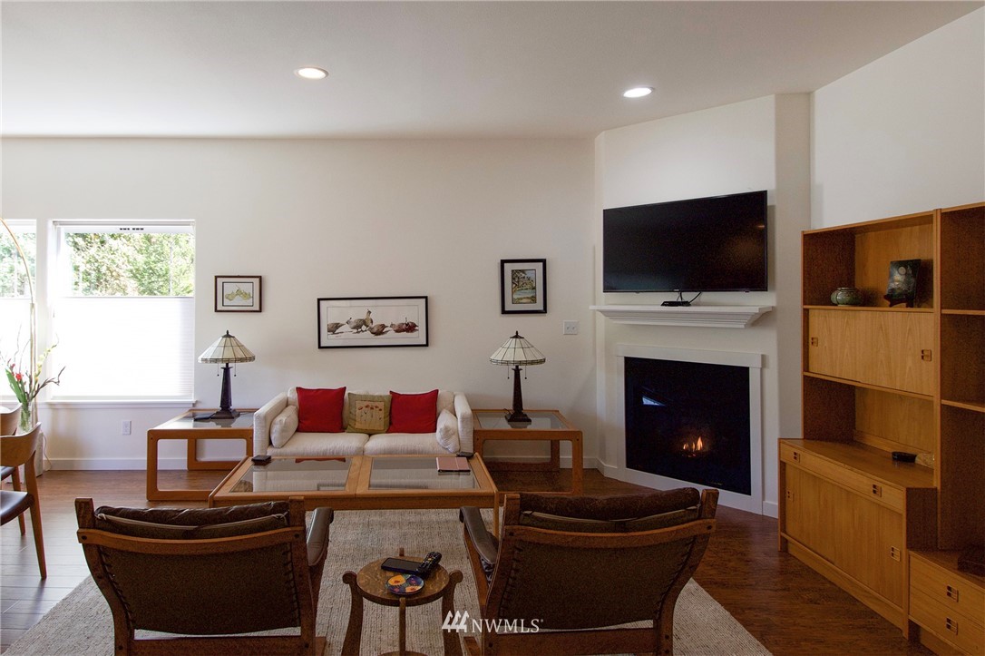 161 Stratus Loop Sequim, WA 98382 - Photo 4 of 34 a living room with furniture a flat screen tv and a fireplace