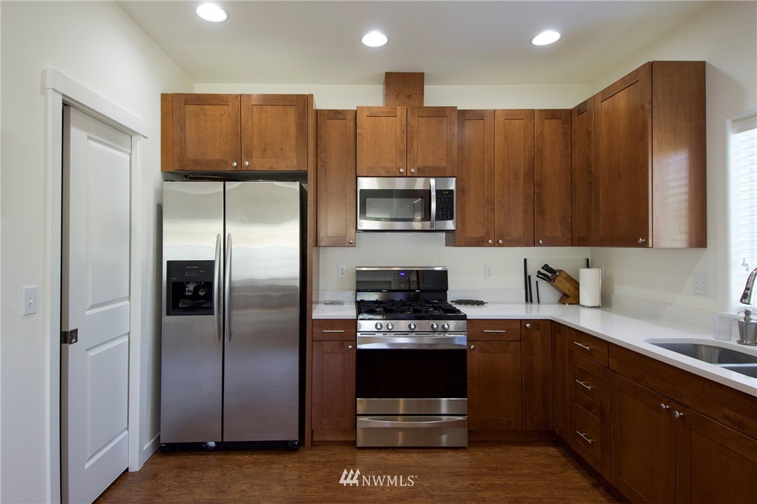 161 Stratus Loop Sequim, WA 98382 - Photo 9 of 34 a kitchen with stainless steel appliances granite countertop a refrigerator a stove a sink and a microwave