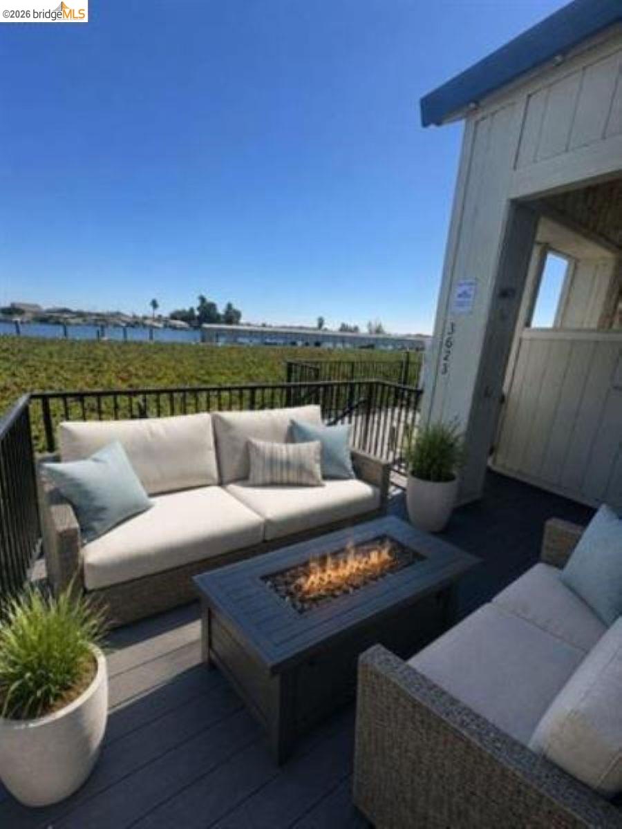 3623 Wells Road Oakley, CA 94561 - Photo 4 of 75 Outdoor deck with dark composite flooring, black metal railing, and a built-in fire pit
