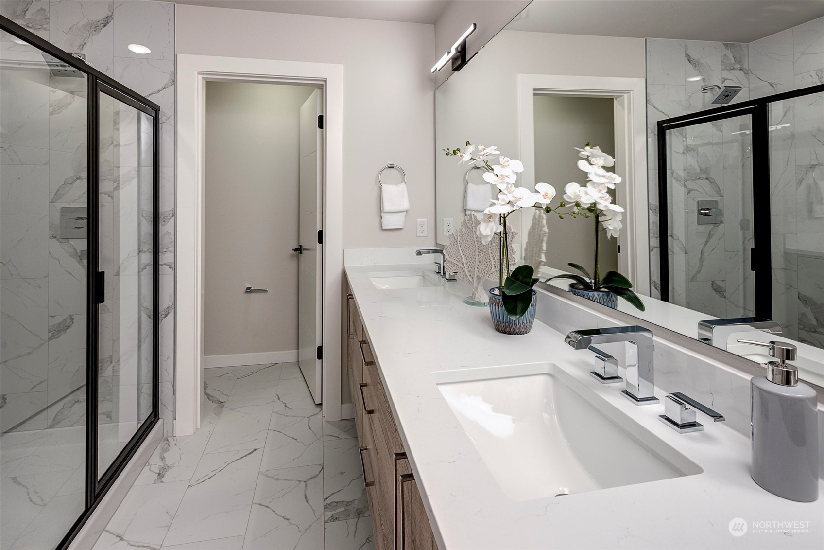 8911 Northeast 173rd Place, Unit A Bothell, WA 98011 - Photo 25 of 34 a bathroom with a double sink sink and shower