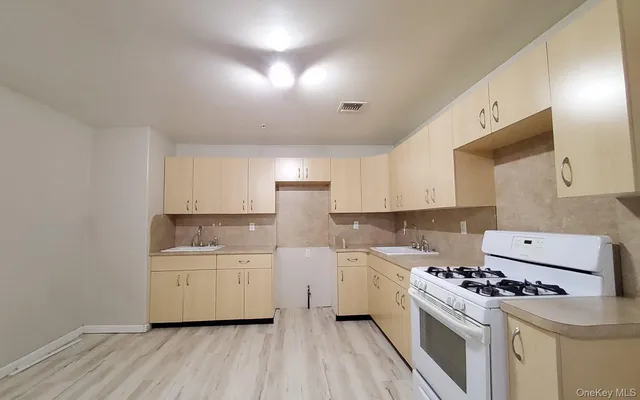 a kitchen with a stove a sink and a refrigerator