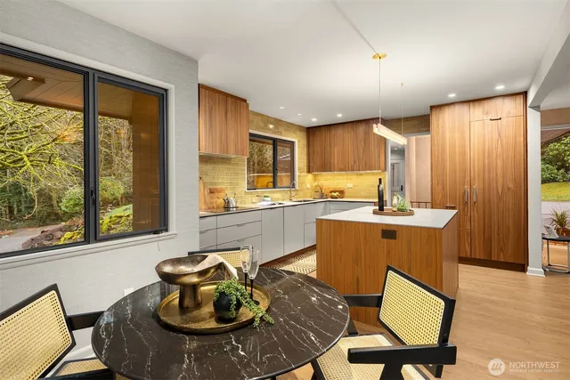 a kitchen with stainless steel appliances granite countertop sink stove and wooden cabinets