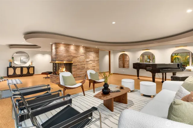 a living room with patio furniture and a large window