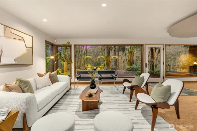 a living room with couches a coffee table and a flat screen tv with wooden floor