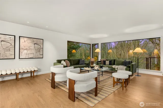 a view of a dining room with furniture large windows and wooden floor