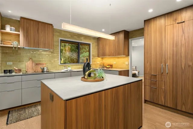 a kitchen with a sink stove and cabinets