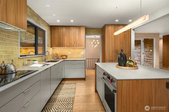 a kitchen with stainless steel appliances granite countertop a sink and cabinets