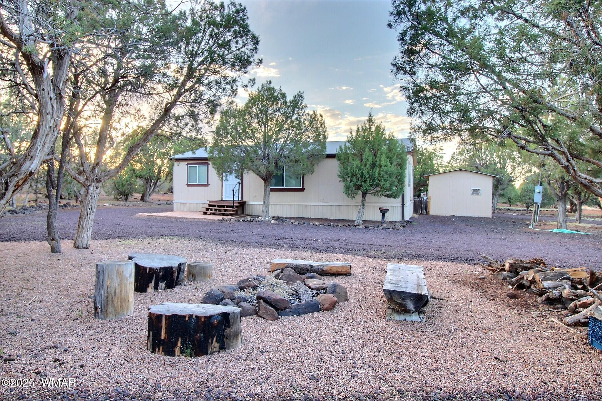 7803 Stokes Lane Show Low, AZ 85901 - Photo 1 of 25 a view of a backyard with table and chairs plants and trees