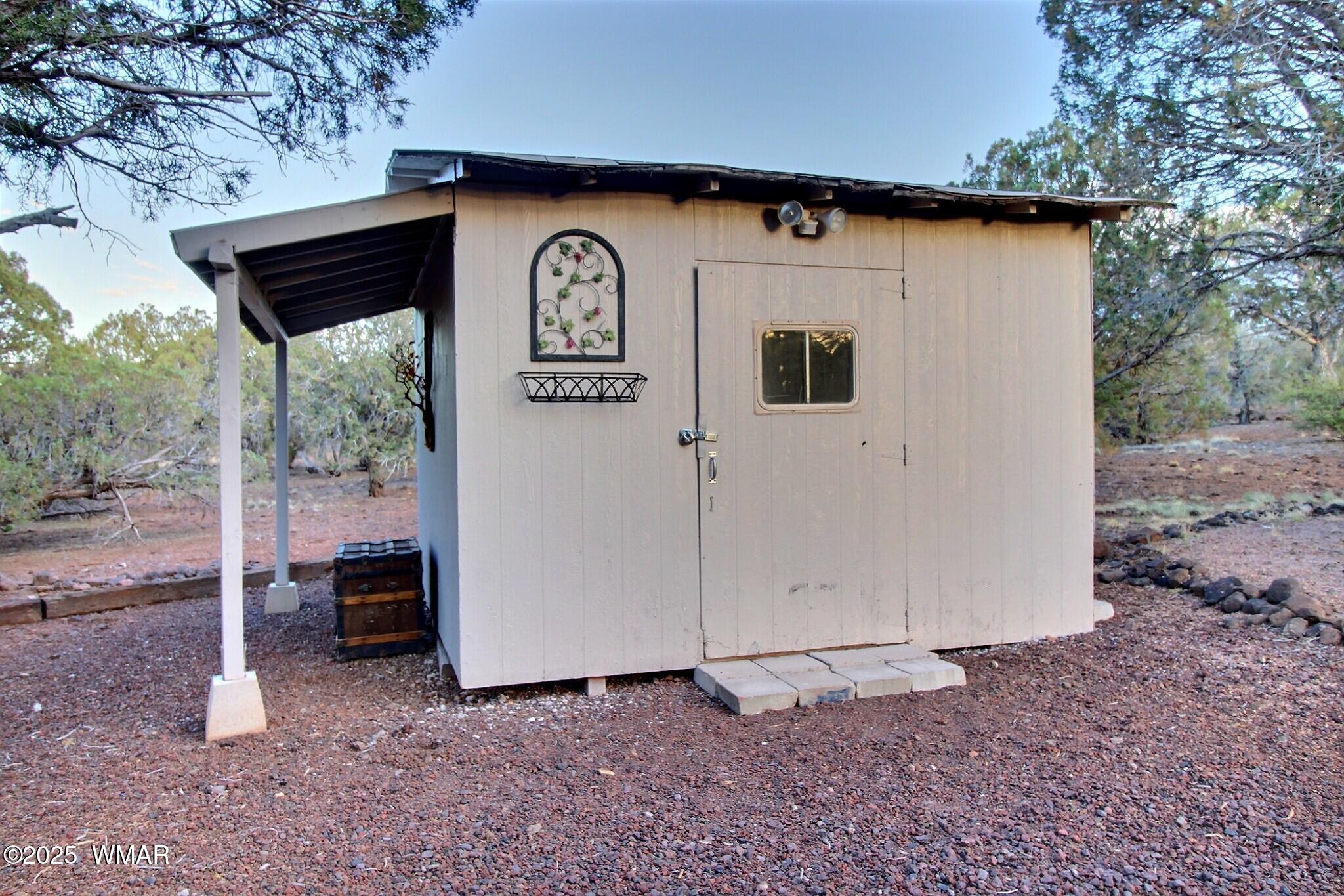 7803 Stokes Lane Show Low, AZ 85901 - Photo 17 of 25 a view of backyard with a barn and a car parked