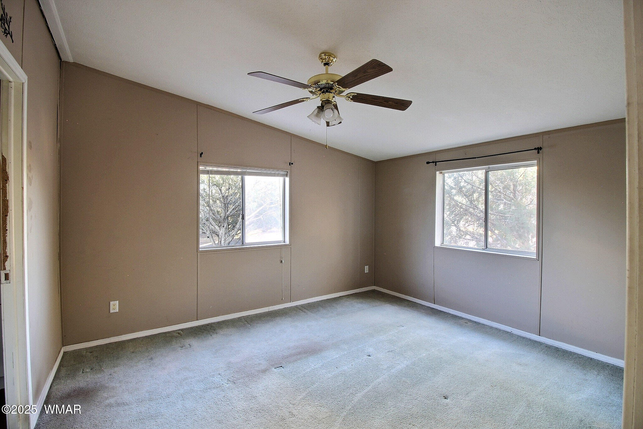 7803 Stokes Lane Show Low, AZ 85901 - Photo 7 of 25 a view of a livingroom with a window and a ceiling fan