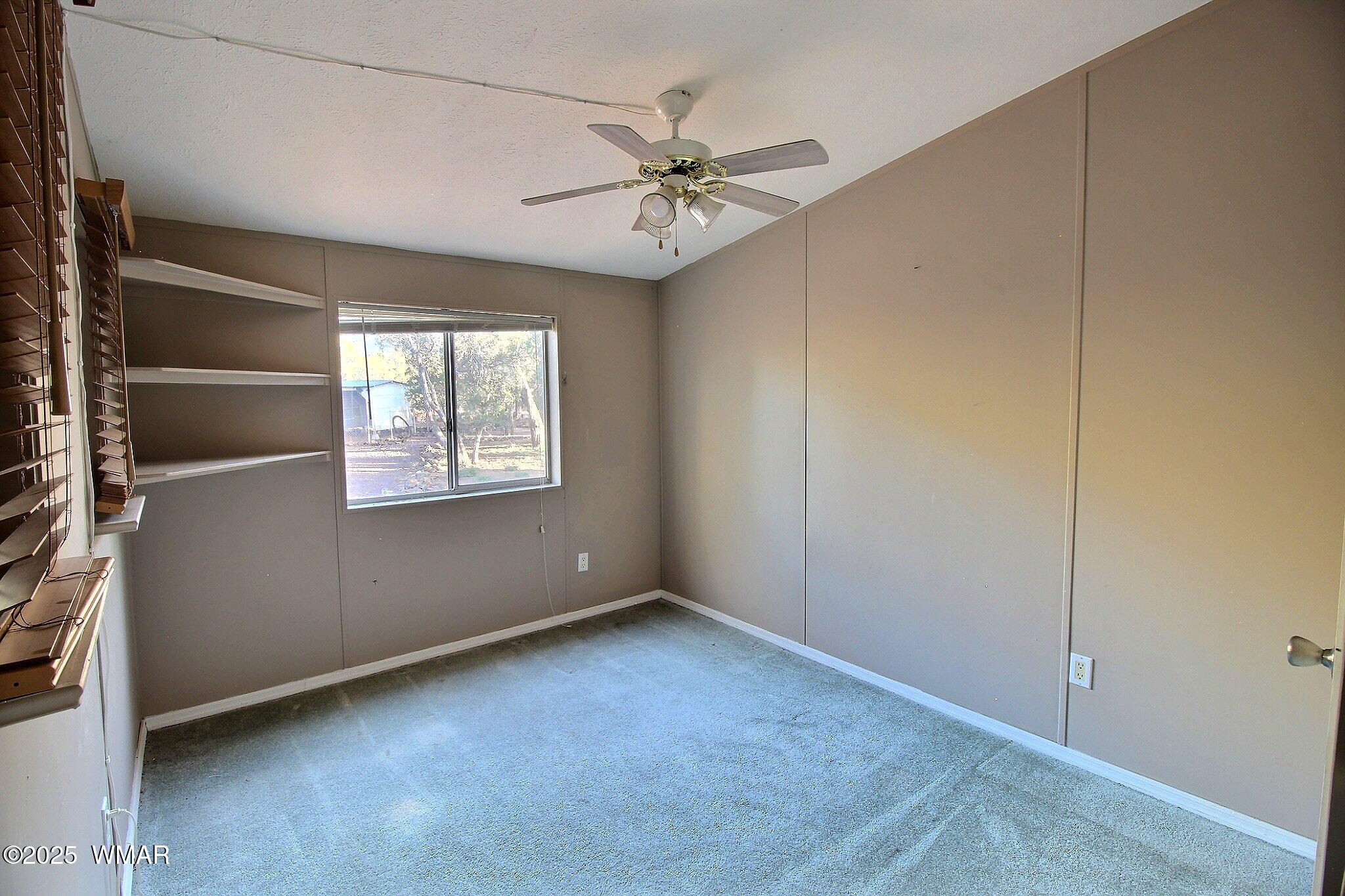 7803 Stokes Lane Show Low, AZ 85901 - Photo 9 of 25 an empty room with windows and fan