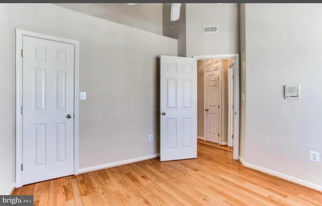 a view of hallway with wooden floor