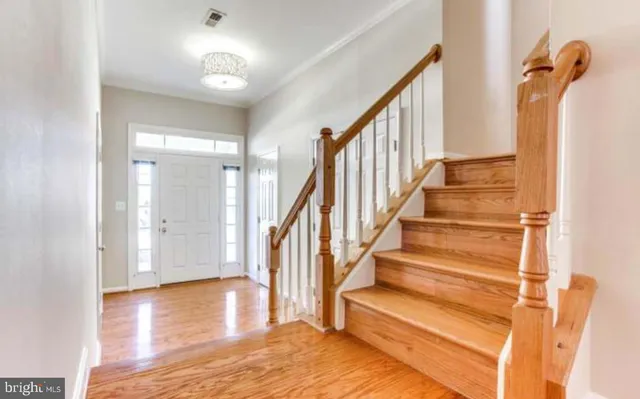 a view of entryway and hall with wooden floor