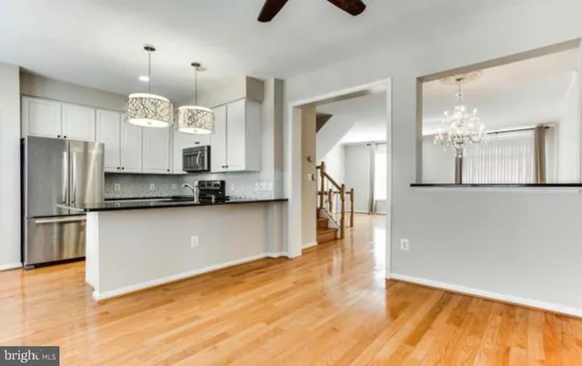 a kitchen with stainless steel appliances a refrigerator sink and microwave