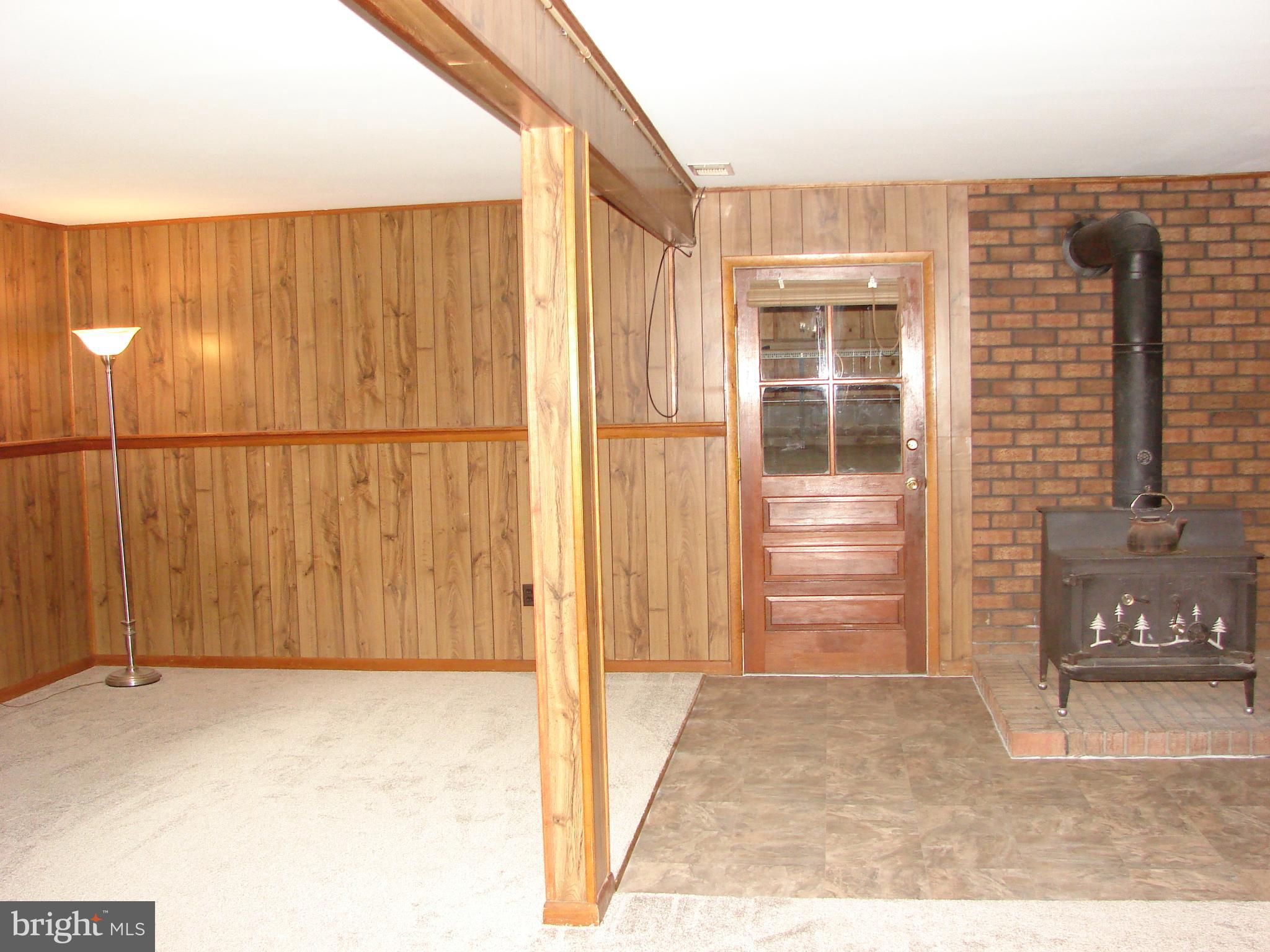 511 Leppo Road Westminster, MD 21158 - Photo 24 of 56 Family room wi/woodstove & garage access