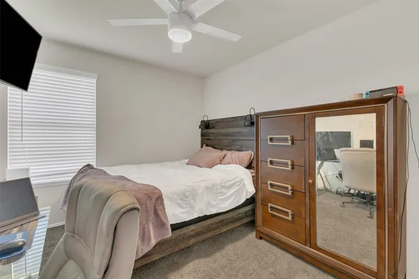 a bedroom with a bed and a flat tv screen