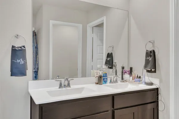 a bathroom with double sink and a mirror
