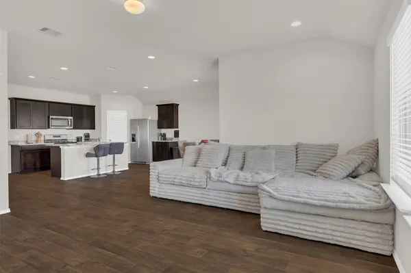 a living room with furniture and kitchen view