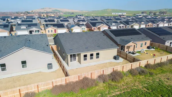 an aerial view of a house with a yard