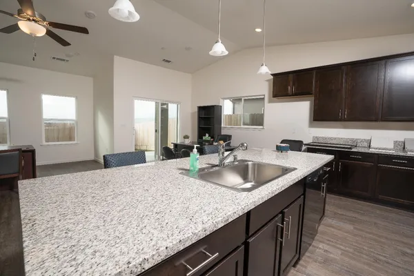 a kitchen with sink cabinets and stove