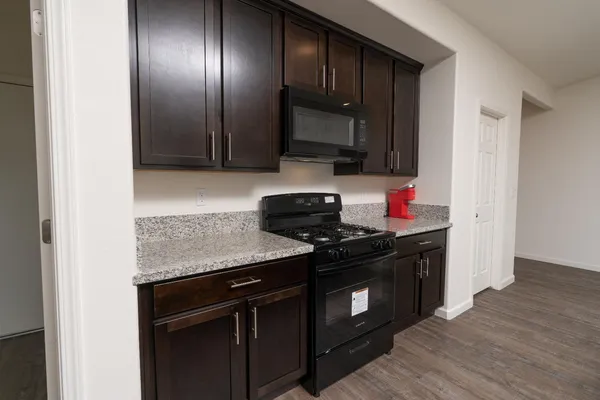 a kitchen with granite countertop stainless steel appliances and wooden cabinets